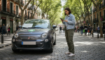 Traveler with eco rental car on Madrid street